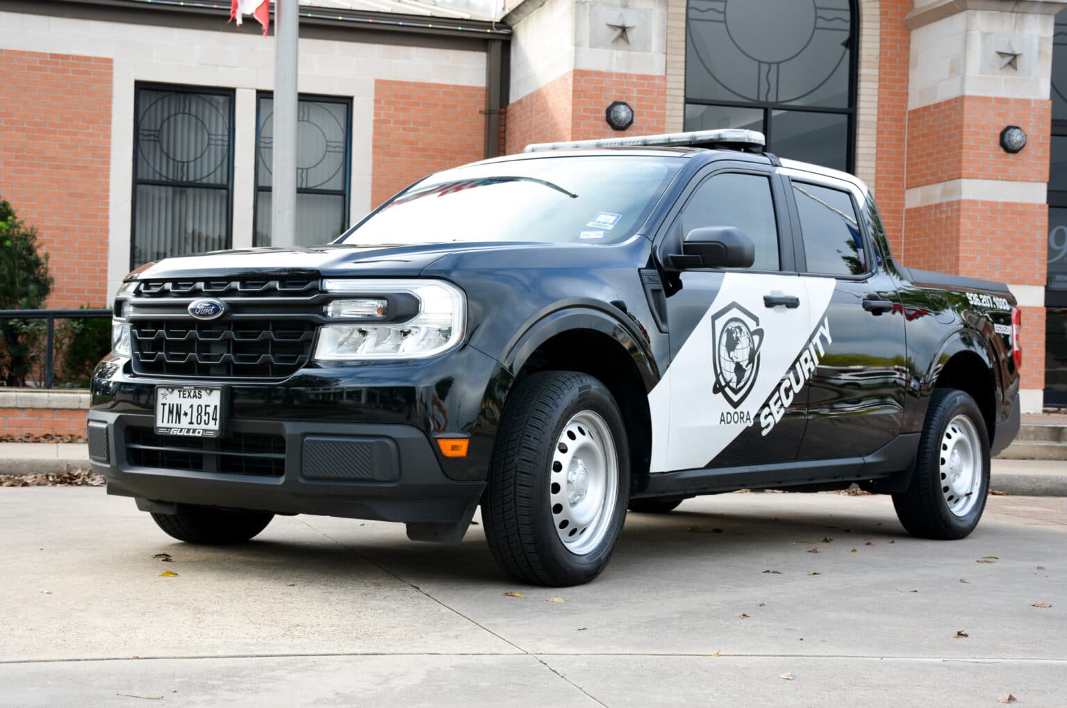 Adora patrol truck in front of a building