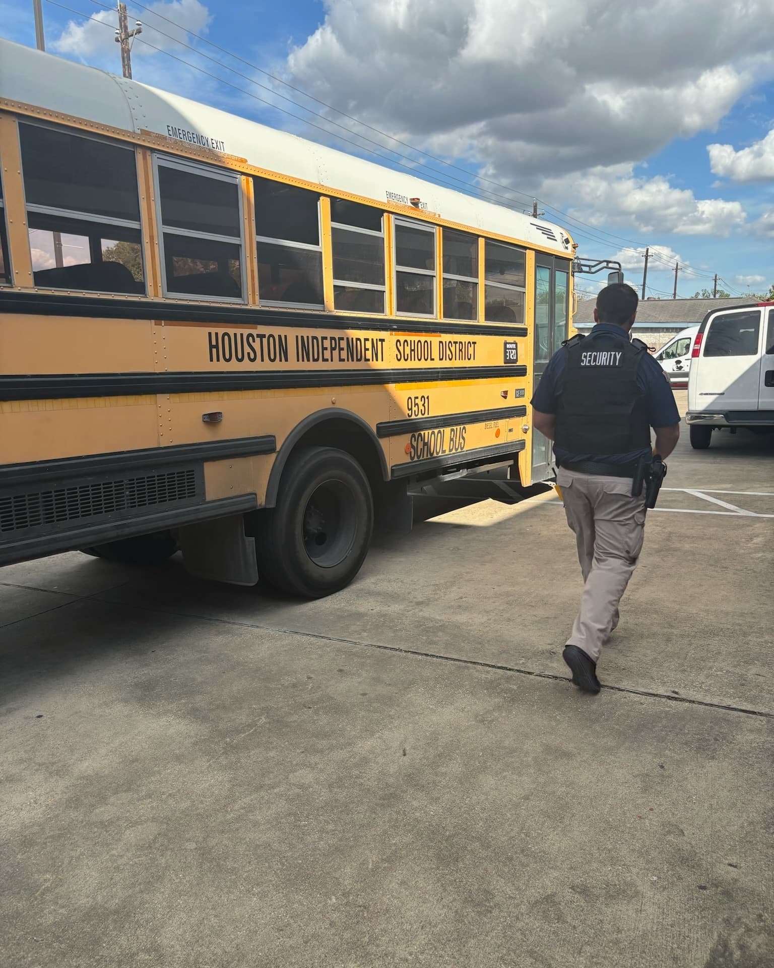 Security officer patroling on foot near a school bus