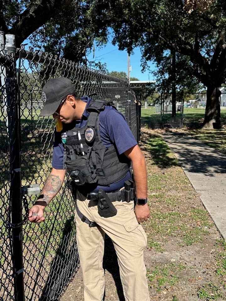 Security officer inspecting the padlock on a gate
